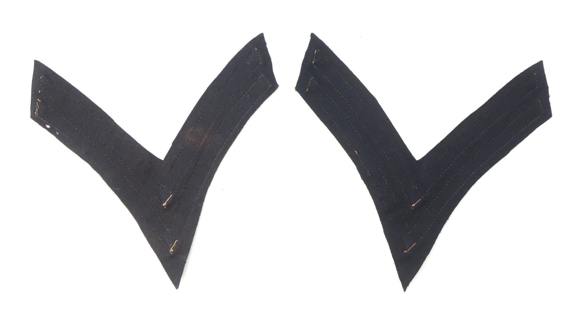 Two Original Civil War Federal Regulation Chevrons for Artillery Corporal, black fabric with visible stitching, displayed side by side on a white background.