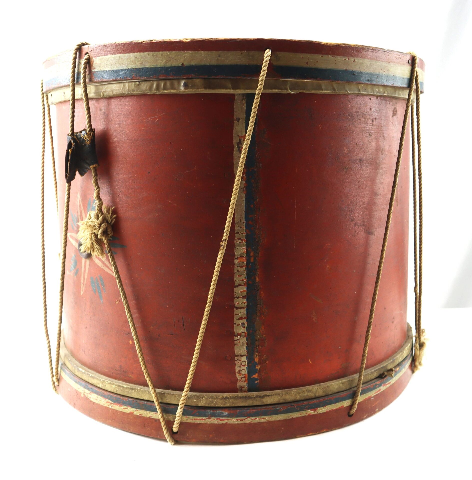 A Civil War Painted Drum featuring red wooden construction, rope tensioning, and metal rims, with visible signs of age and wear.