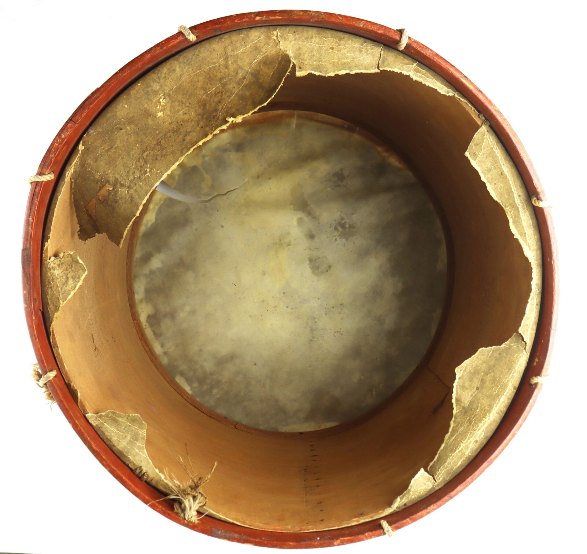 Top view of the Civil War Painted Drum featuring a circular shape, reddish-brown rim, and a torn drumhead with visible edge wear.