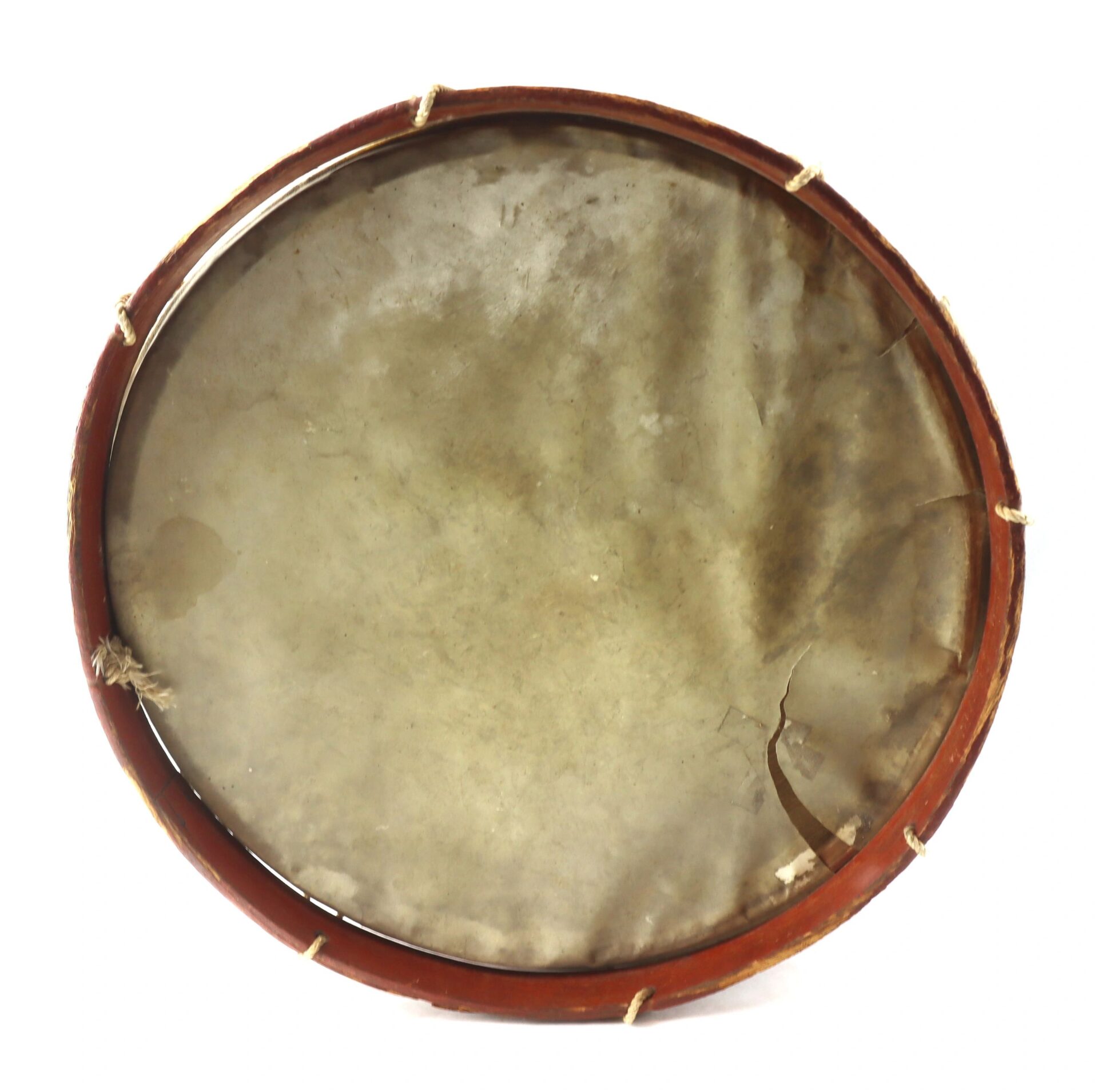 The Civil War Painted Drum is a round frame drum featuring a wooden rim, natural drumhead with visible discoloration and a tear on the lower right, all secured with white cords.