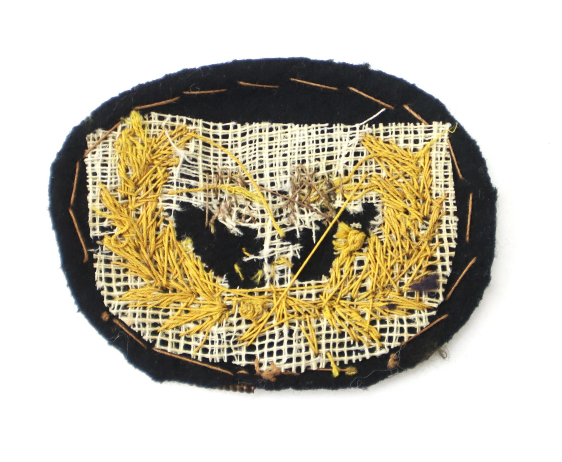 The Civil War U.S. Staff Wreath Hat Insignia is an oval fabric patch featuring gold embroidery, black felt backing, and white mesh with visible stitching on the reverse side.