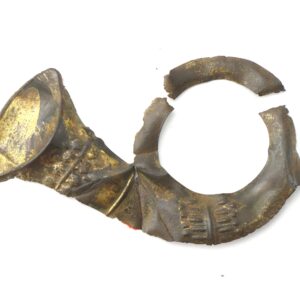 A Civil War Infantry Hunting Horn Device: a bent, broken metallic ring with a trumpet-shaped extension, displaying worn, tarnished, and textured surfaces.