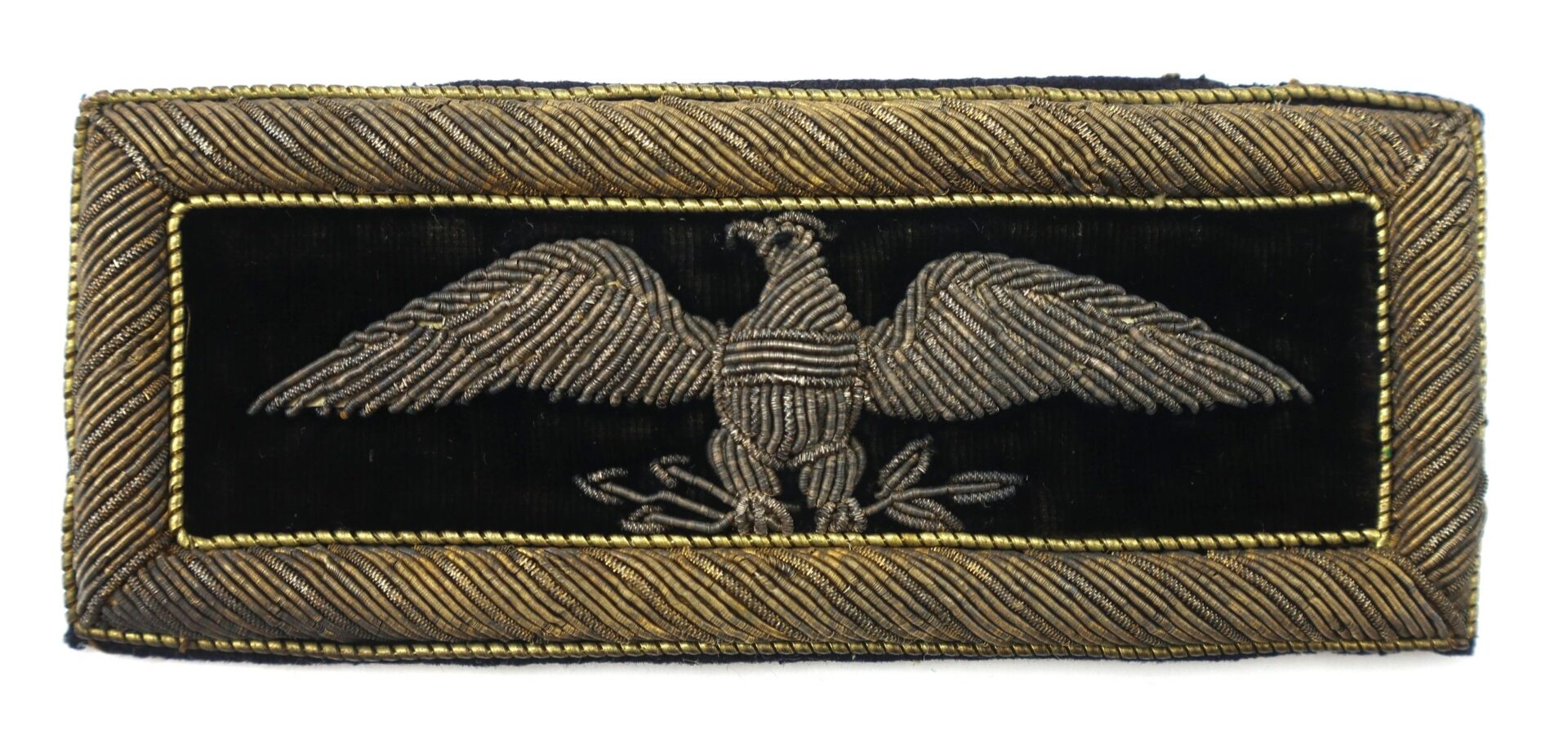 The Colonel of Staff Shoulder Bars feature a rectangular black patch with a silver embroidered eagle spreading its wings, bordered by a gold and black chevron pattern.