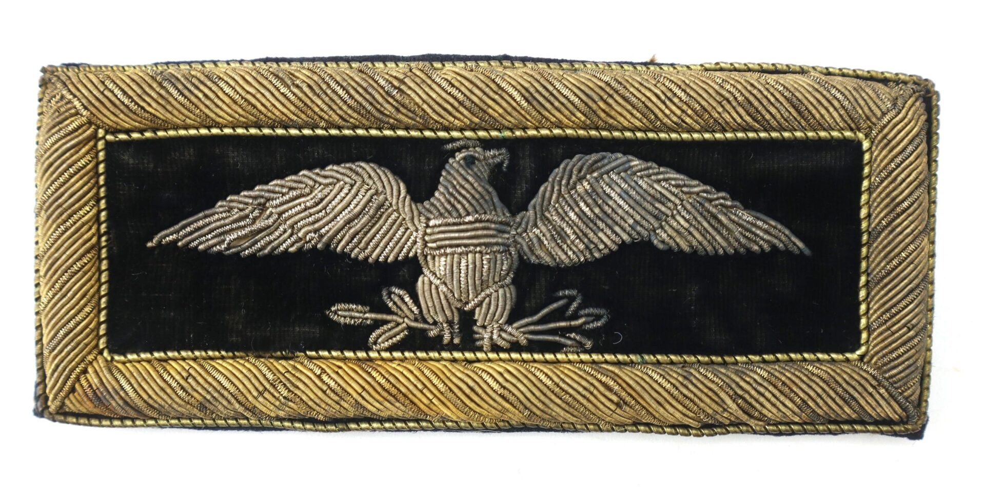 The Colonel of Staff Shoulder Bars feature a rectangular black patch with a silver embroidered eagle holding arrows and an olive branch, bordered by gold trim.