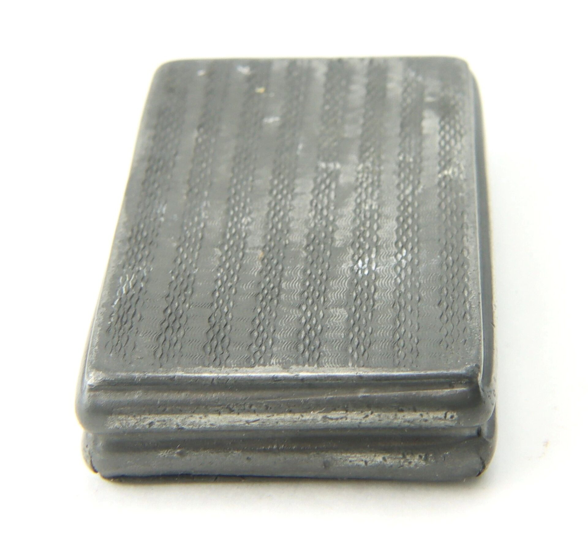 A Civil War Snuff Box, rectangular and textured with a gray metal finish and slightly raised border, is displayed against a white background.