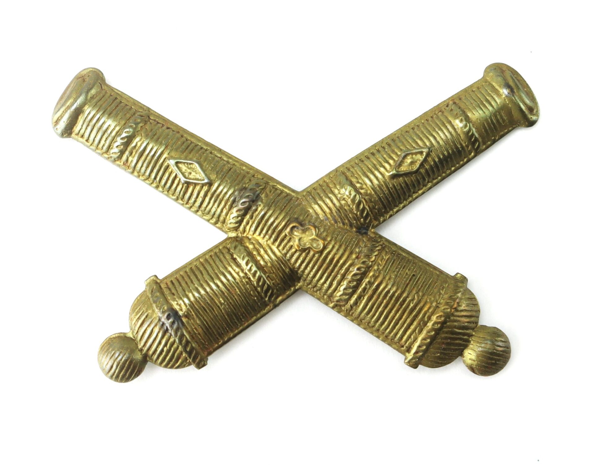 The Officer’s False Embroidered Artillery Insignia, now sold, features two crossed cannons on a white background, representing artillery.