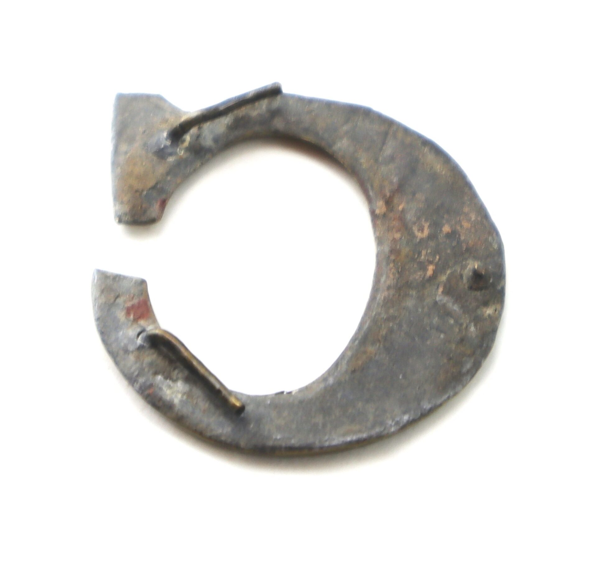 A close-up of an Original Civil War Brass Hat Letter "C" – Company Designation, featuring its circular shape and historic patina against a white background.