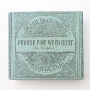 A vintage blue box labeled "Prairie Pine Weed Root" from A.T. Wise Woodward & Co., Peoria, Illinois, features a decorative border and text.
