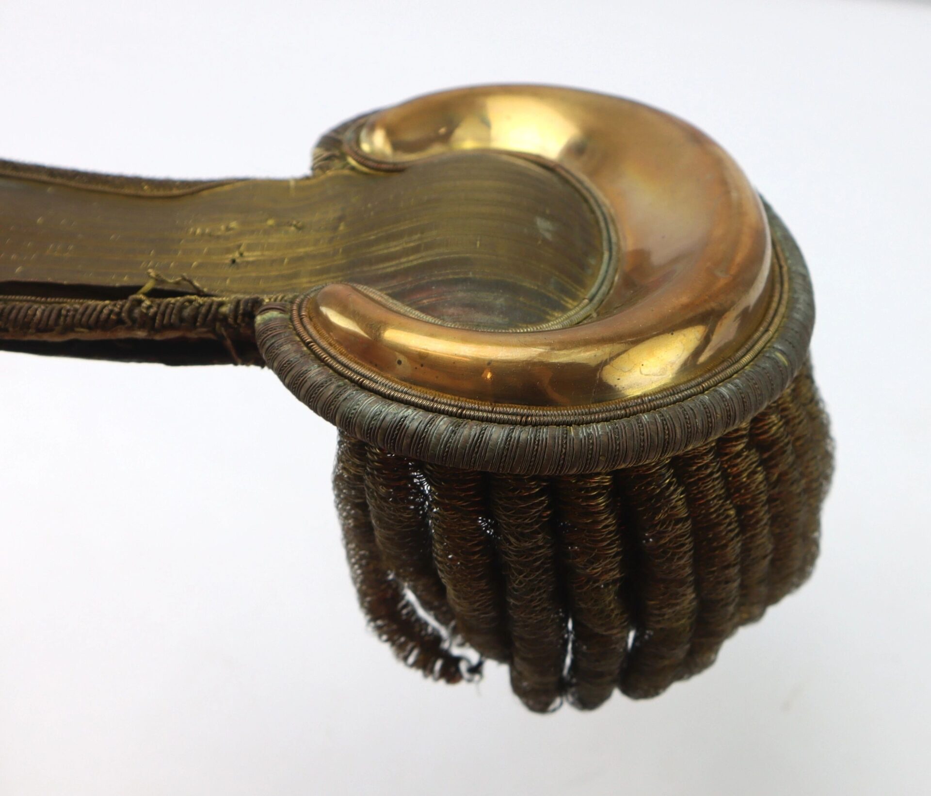 A close-up of the U.S. Officer’s Epaulettes, featuring a gold-colored metal plate and coiled bullion fringe, displayed on a white background.