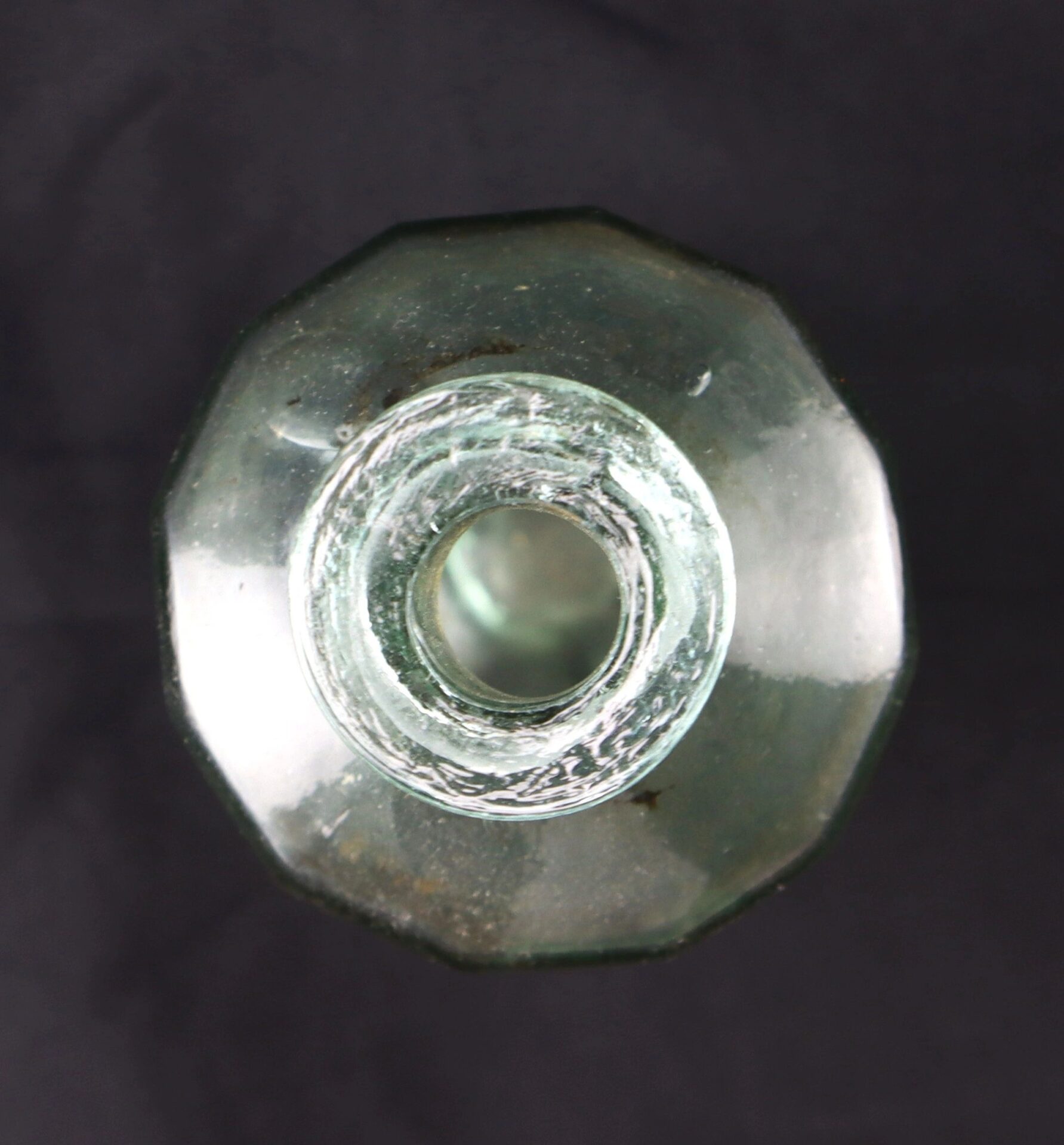 Top-down view of the Apothecary Bottle – Fluid Extract Hyssop, a clear octagonal glass bottle with a wide opening, set against a dark background.