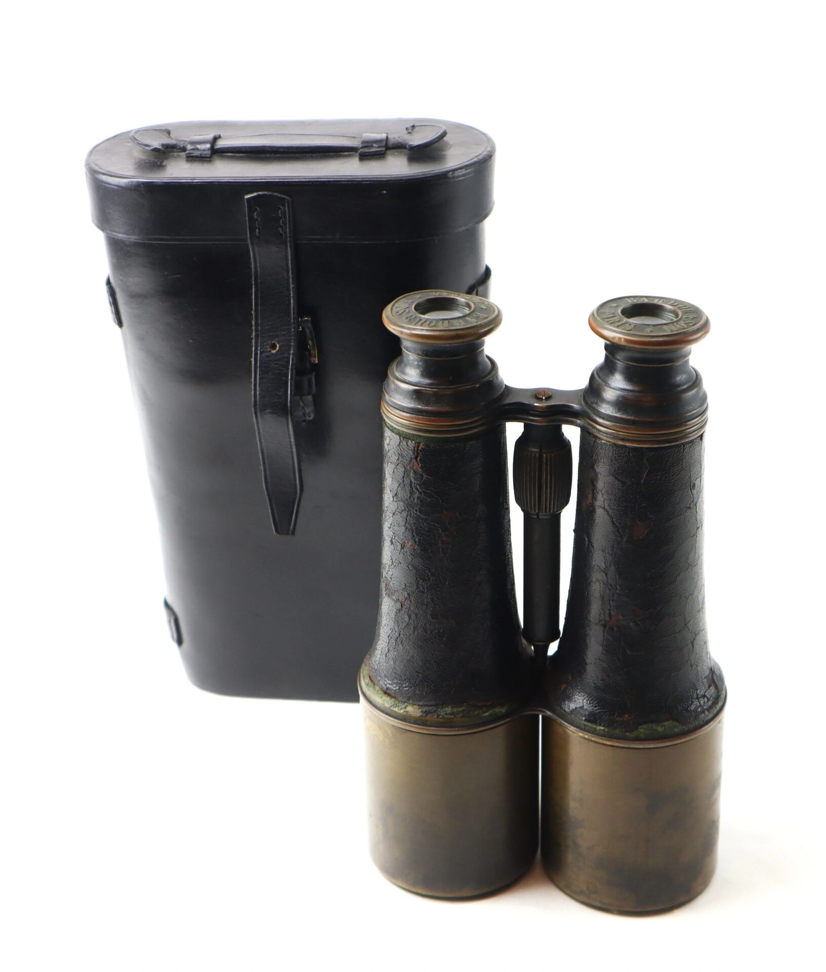 A pair of Bardou & Son Paris Binoculars with a worn leather covering is displayed in front of a black leather carrying case, set against a white background.