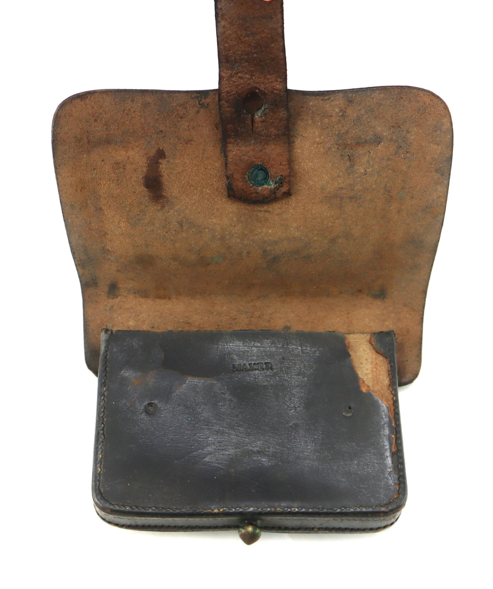 A Civil War Pistol Cartridge Box by J. Davy & Co. with a flap open, displaying visible stains, discoloration, and aging on both the interior and exterior surfaces.