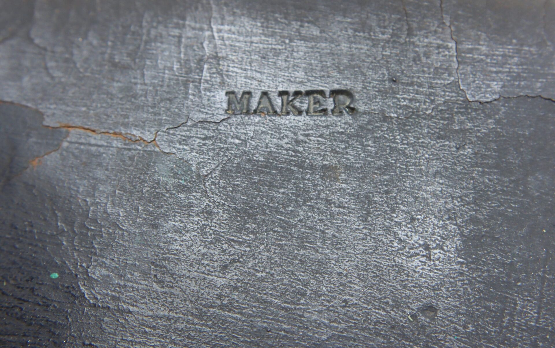 The words "J. Davy & Co." are stamped in uppercase letters on the rough, dark, cracked surface of a Civil War Pistol Cartridge Box.