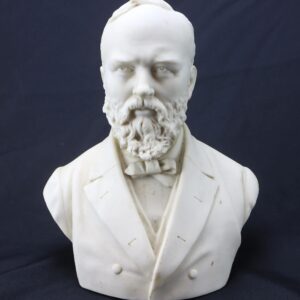 James A. Garfield Parian Bust – 19th Century Memorial Sculpture featuring a bearded man in a suit and bow tie, crafted in white marble and set against a dark background.