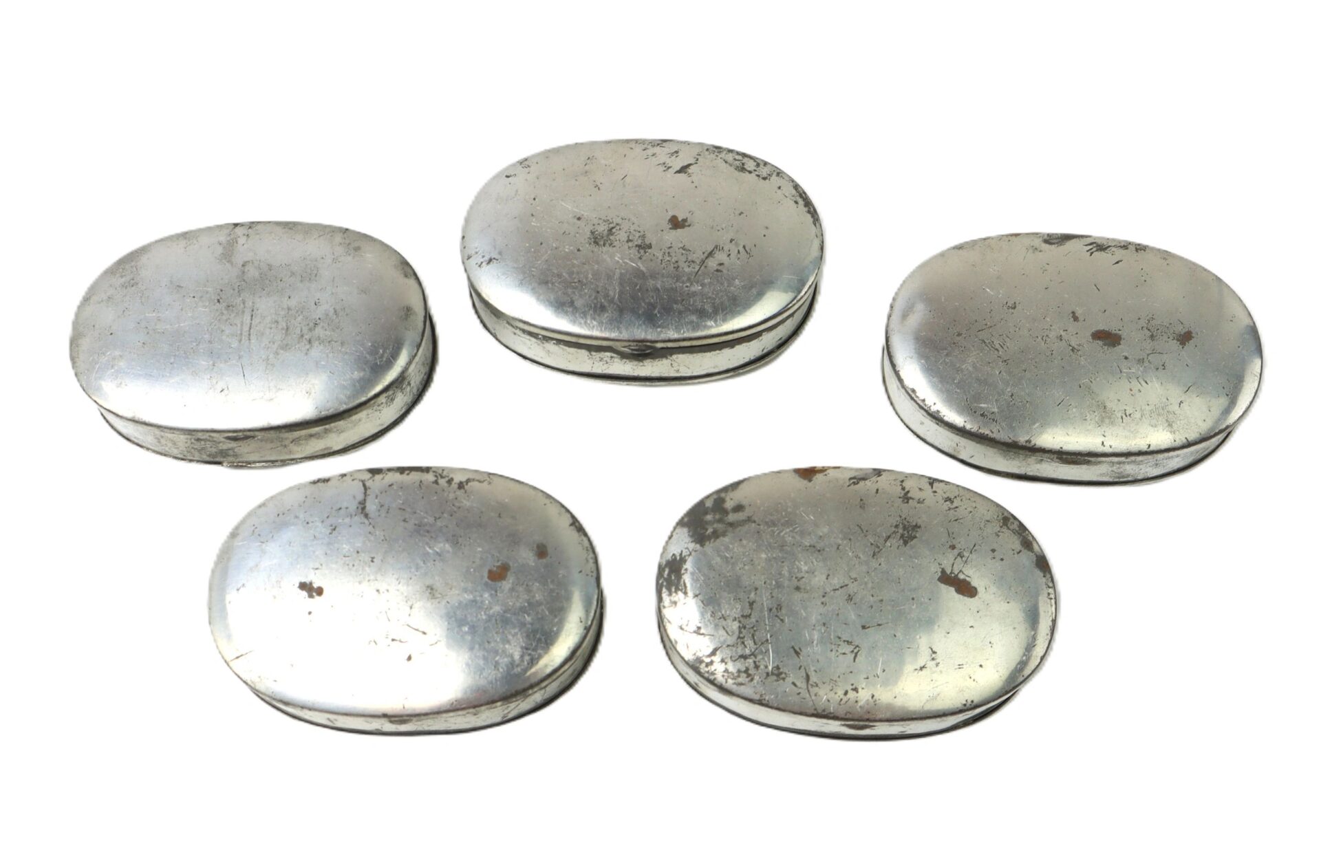 A Boxed Set of 5 Parker Patent Tobacco Snuff Boxes – “New Old Stock” in original box, featuring five silver oval metal boxes arranged in a loose semicircle on a white background.