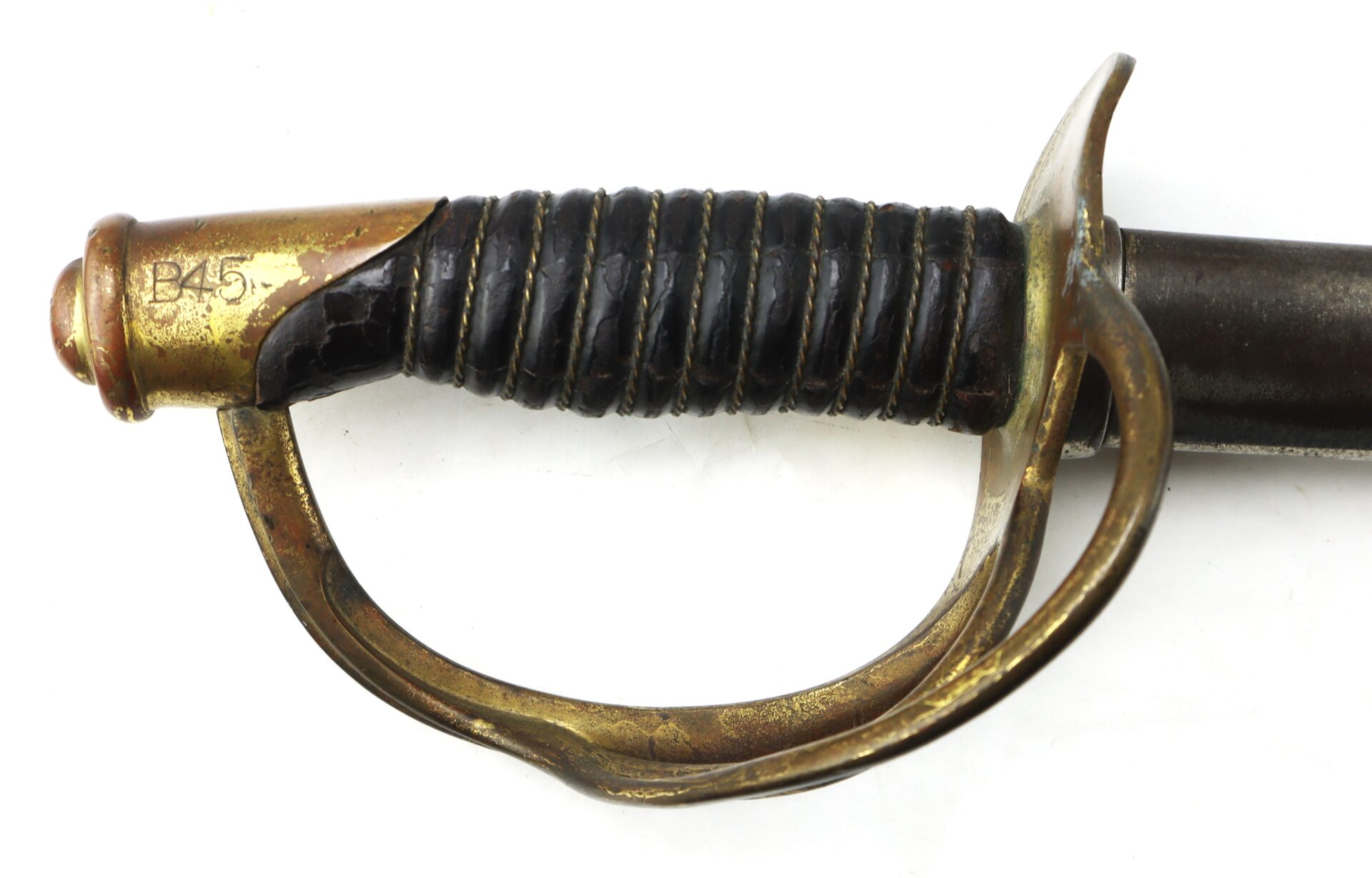 Close-up of an antique brass-hilted sword with a black leather-wrapped grip and handguard, showing some wear and a number "B45" engraved on the pommel.