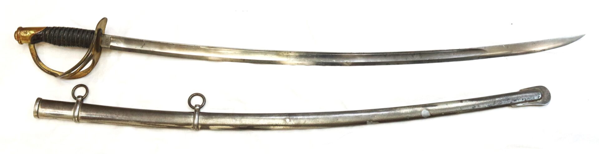 A curved cavalry saber with a brass guard and a black grip is shown above its metal scabbard with two suspension rings, all displayed on a white background.