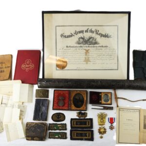 A collection of Civil War-era memorabilia including documents, medals, photos, badges, a framed certificate, books, and various military items arranged together on a white background.