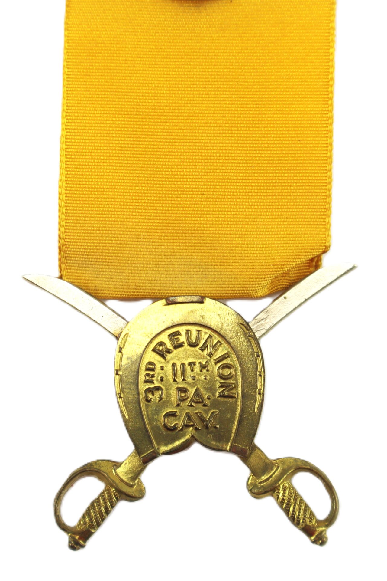 A gold reunion medal with a yellow ribbon, featuring crossed swords and a horseshoe inscribed with "3rd REUNION 11th PA CAV.