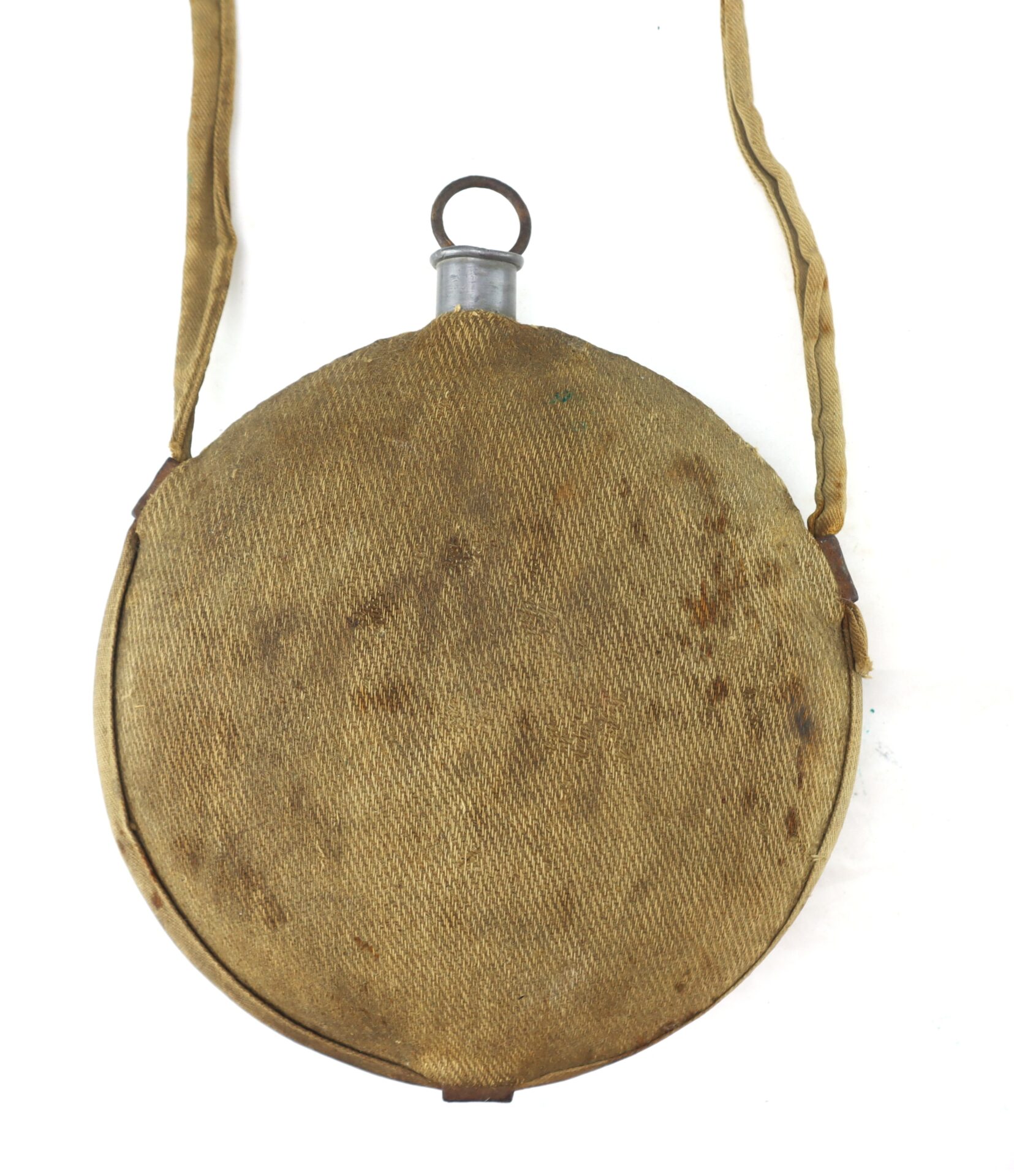 A round, vintage canvas canteen with a fabric strap and metal cap, showing signs of wear and age.