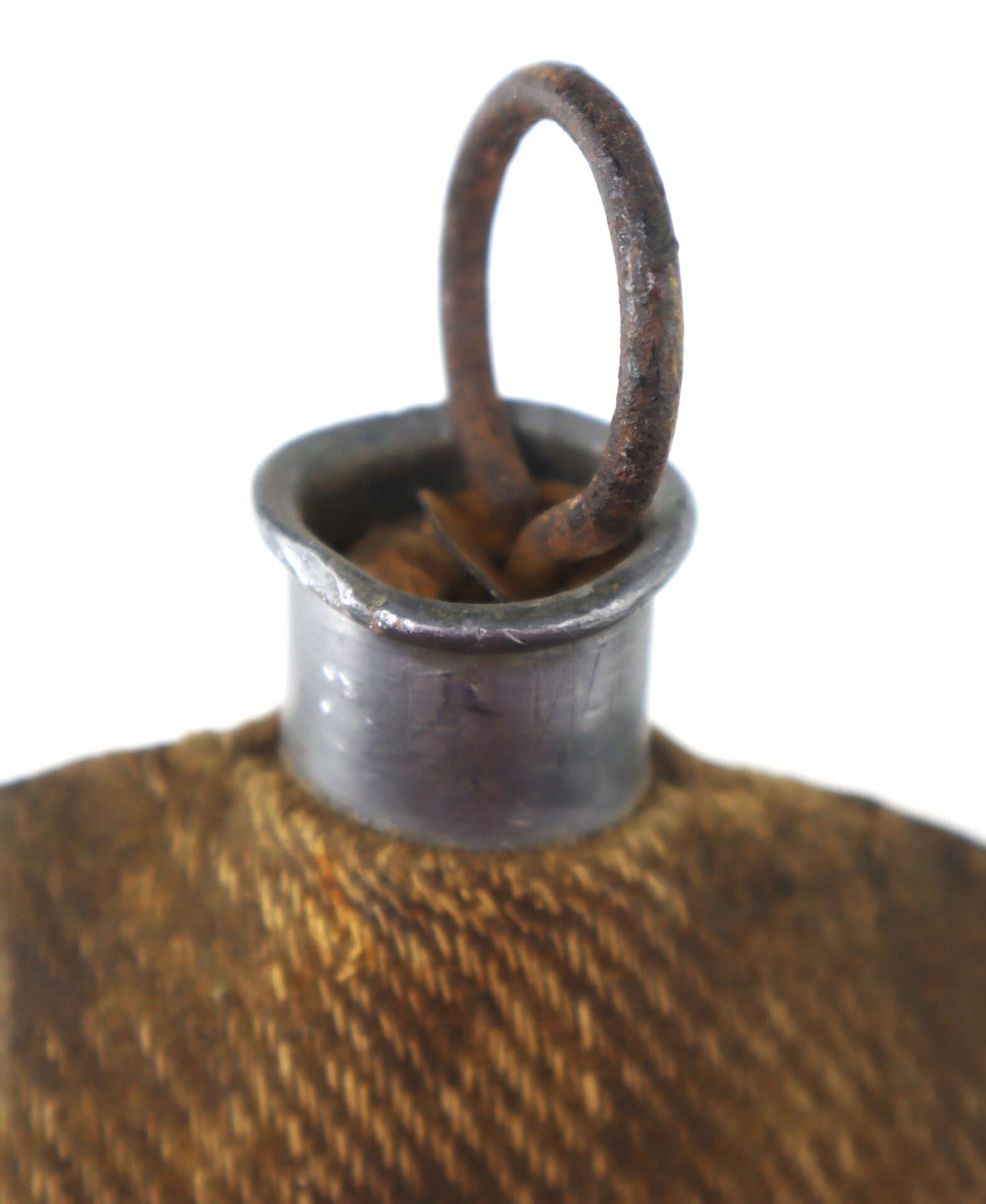 Close-up of a metal canteen neck with a fabric covering and a rusted wire loop on top, isolated on a white background.