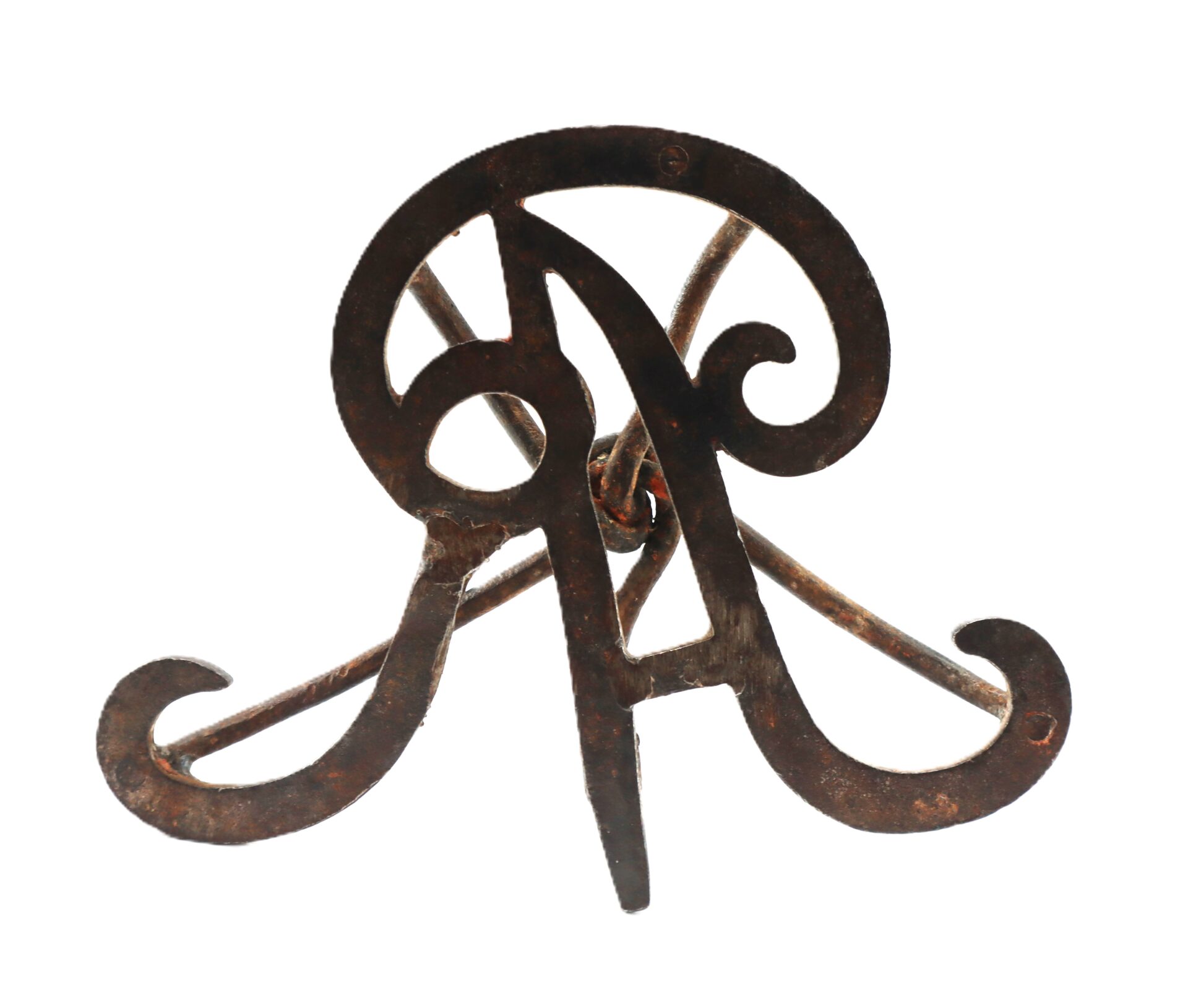 A vintage wrought iron book stand with ornate scrollwork, viewed from the front against a white background.