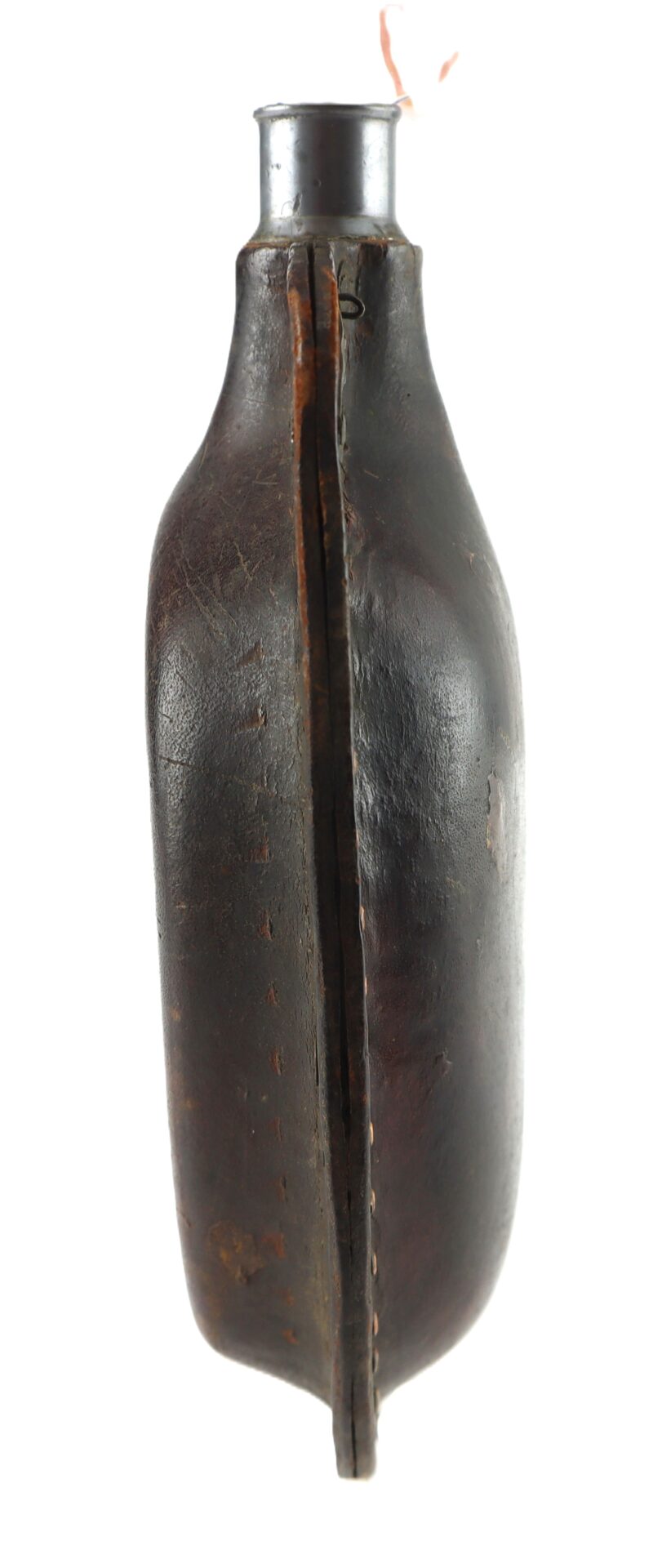A vintage metal canteen covered in stitched, worn brown leather, viewed from the side, with a narrow neck and a visible seam along the length.