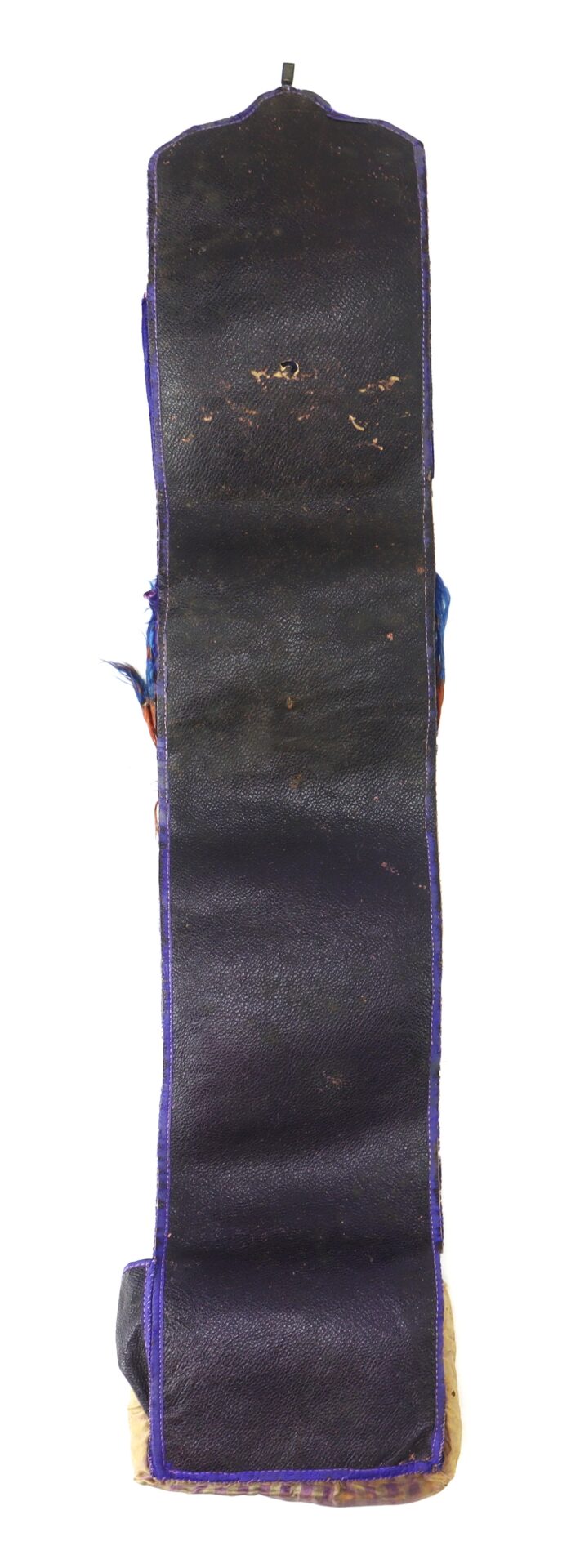 A long, narrow, dark-colored leather or fabric item with visible wear, bordered by purple trim, shown against a white background.