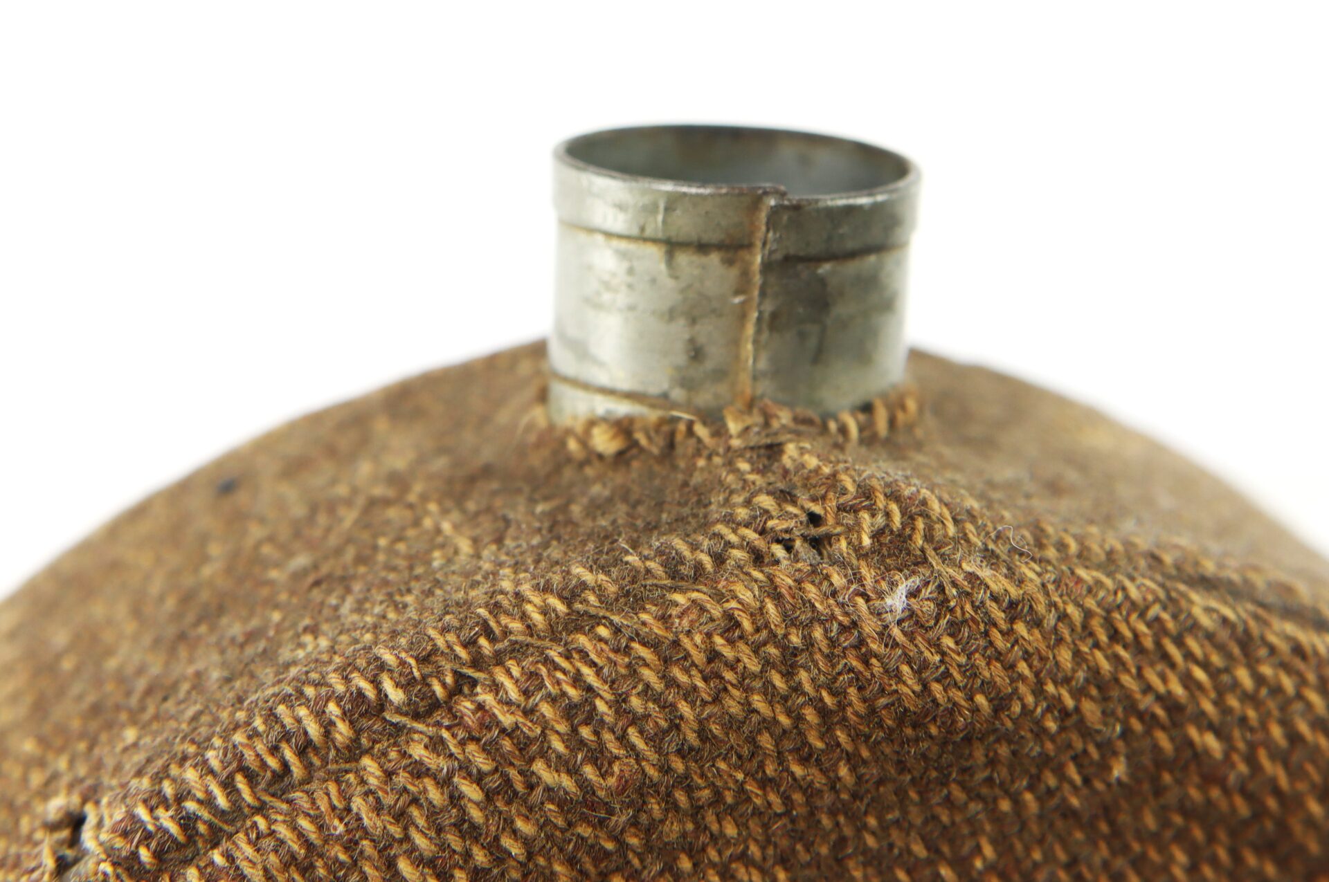 Close-up of the metal spout of a canteen covered in coarse brown fabric, with visible stitching and texture.