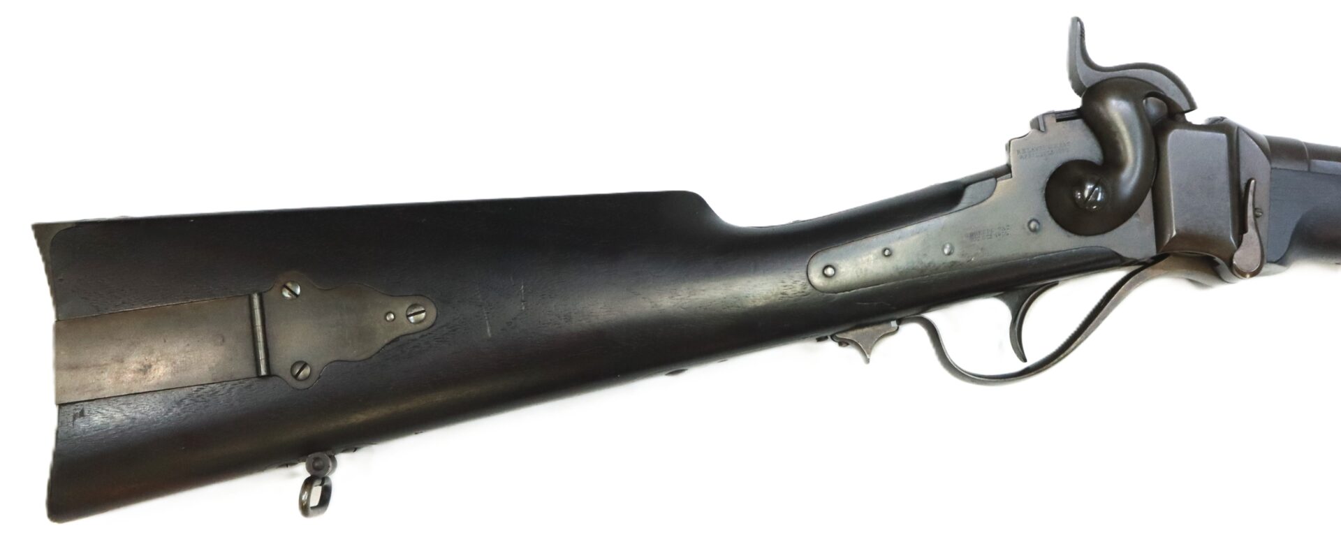 Close-up of the stock and action of an antique black powder rifle with a metal buttplate, lever, and hammer, set against a white background.