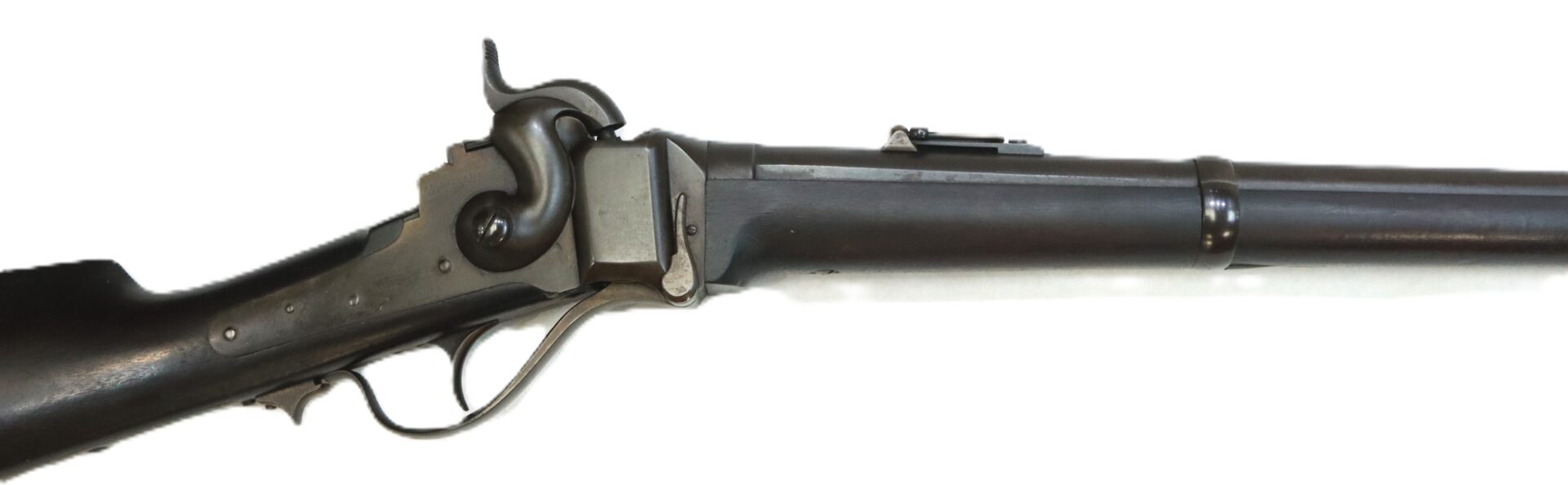 Side view of a vintage black lever-action rifle with a metallic receiver and a partially visible wooden stock, displayed on a white background.