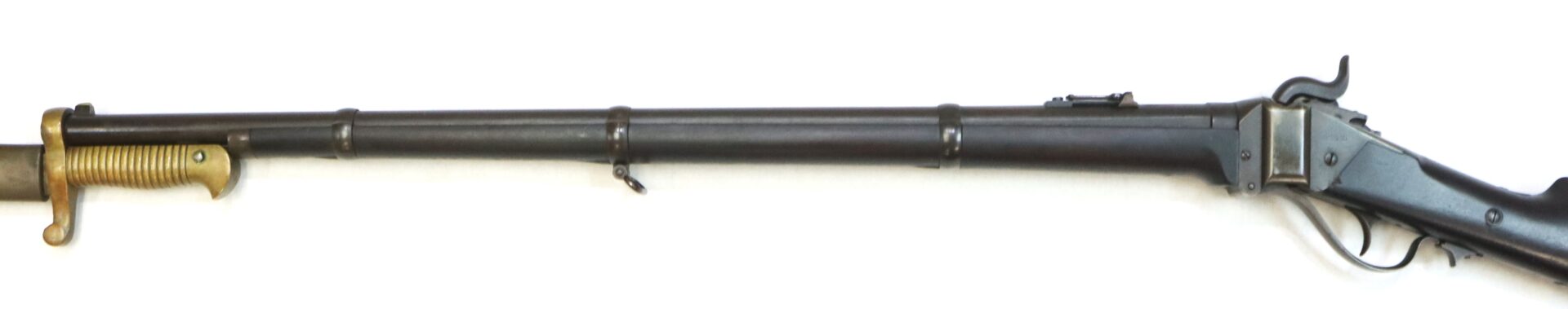 Antique rifle with a mounted bayonet attached underneath the barrel, featuring a lever-action mechanism and a metal finish.