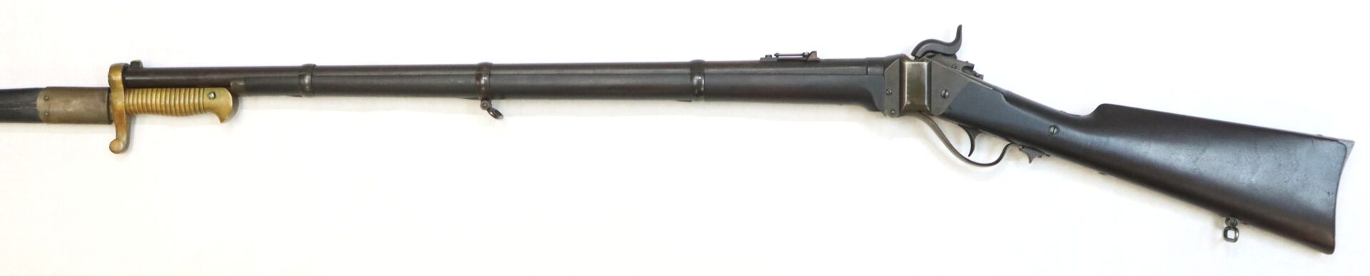 A vintage black rifle with a wooden stock, three barrel bands, and a bayonet attachment near the muzzle.