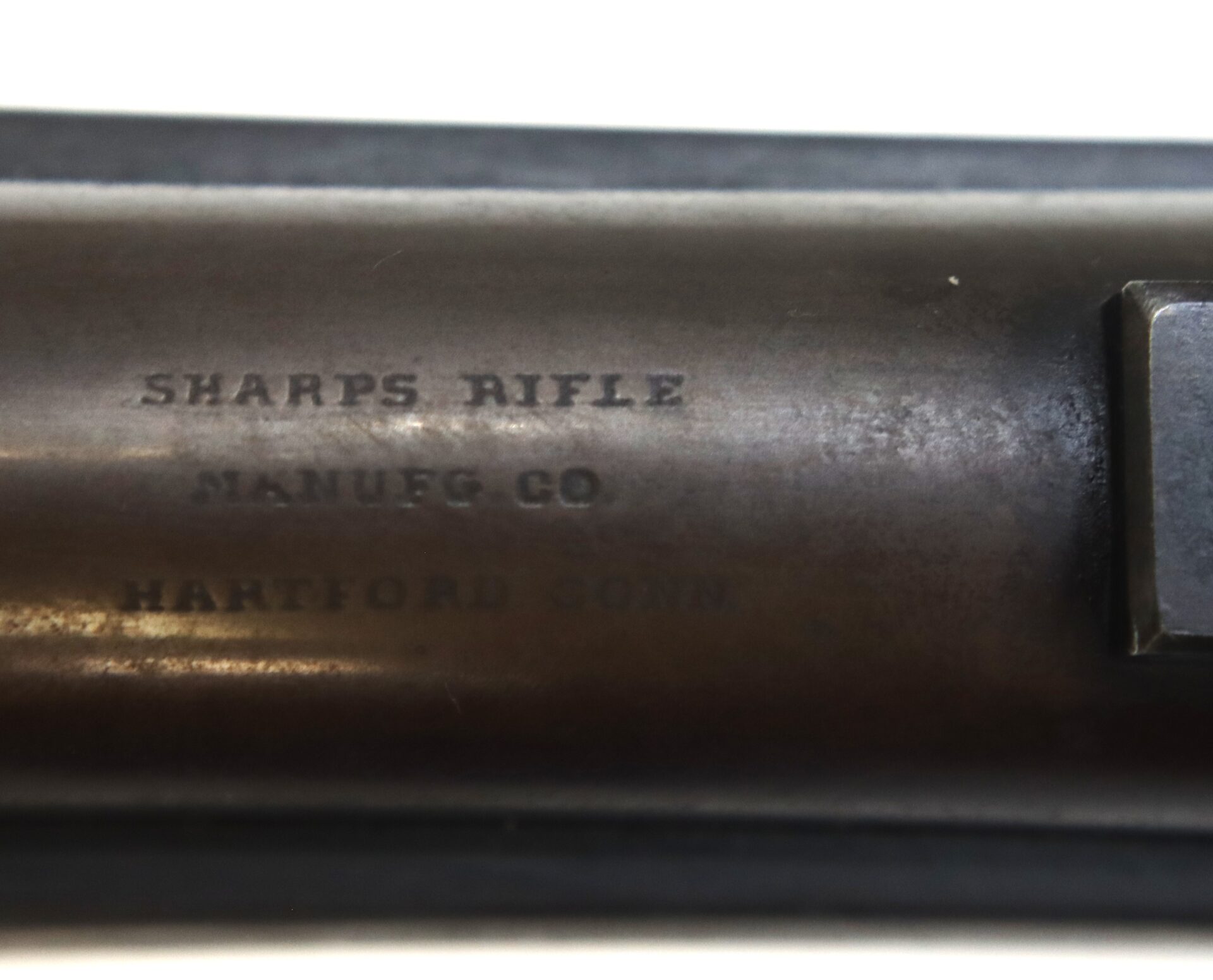 Close-up of a metal surface engraved with the text "SHARPS RIFLE MANUFG CO HARTFORD CONN.