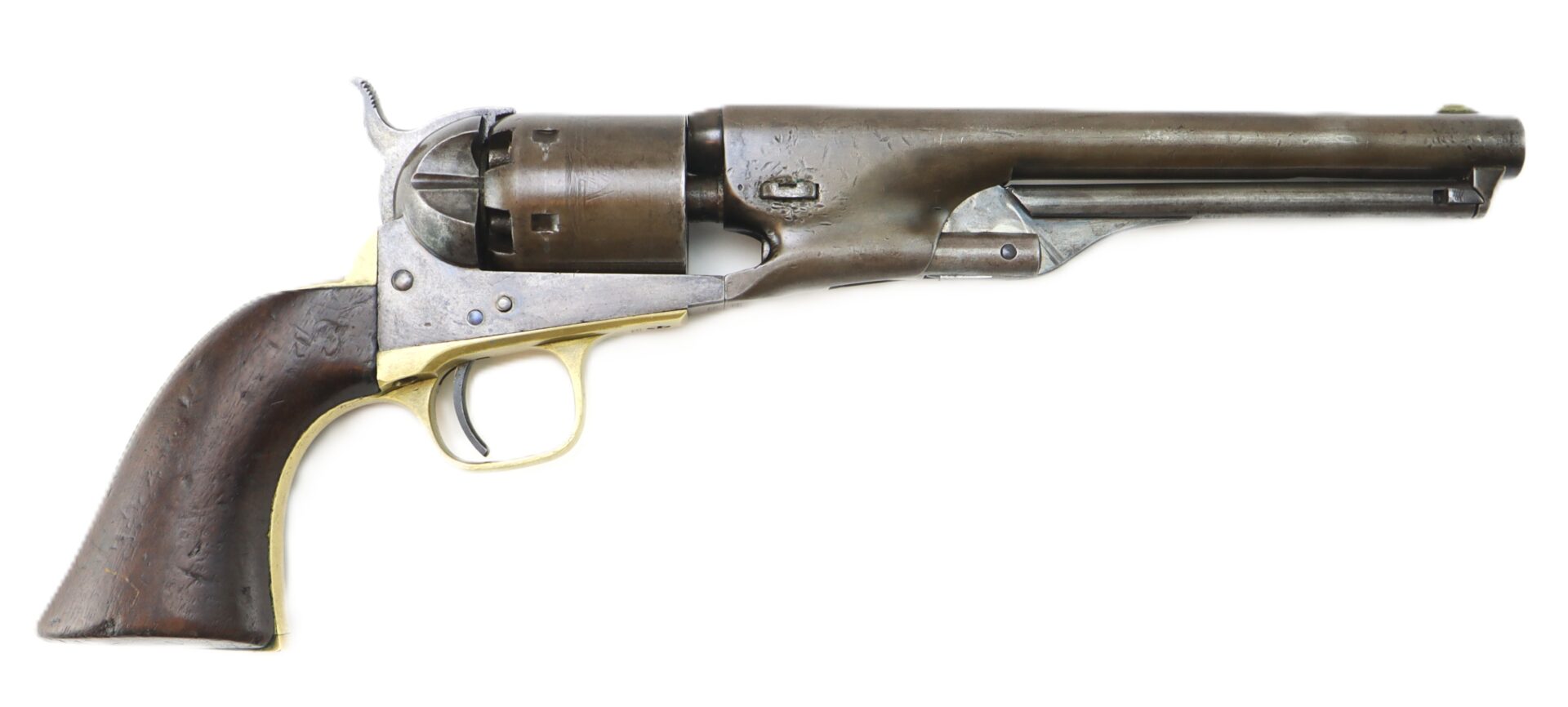 A vintage black powder revolver with a wooden grip, brass trigger guard, and a long metal barrel, photographed on a white background.