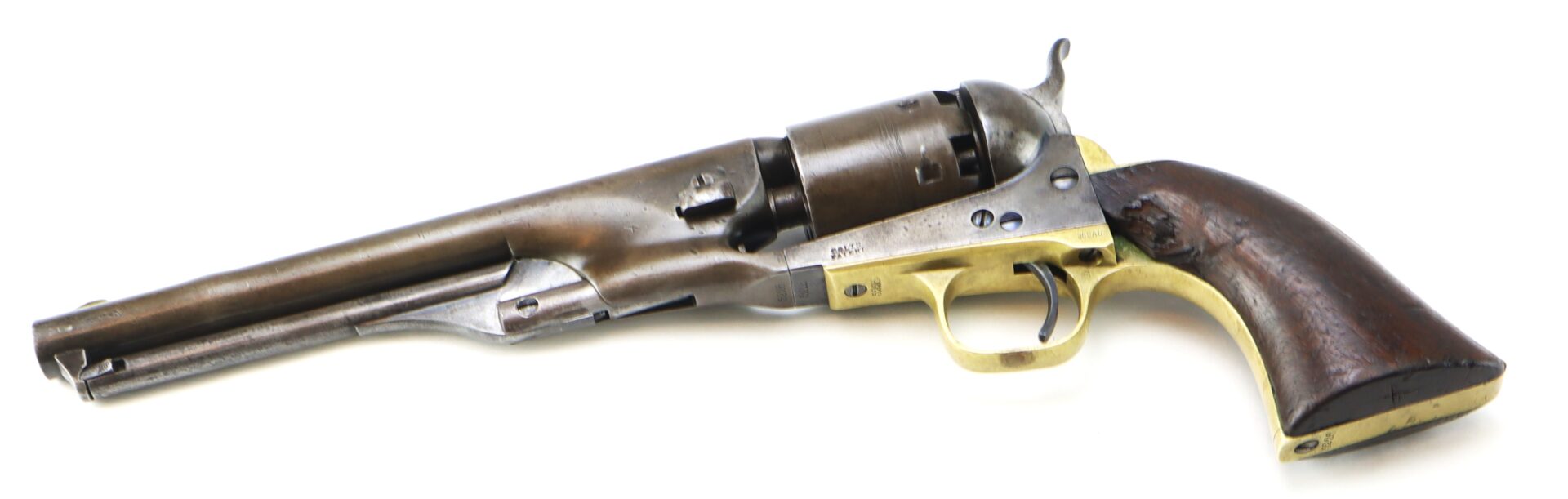 A vintage revolver with a long barrel, wooden grip, brass trigger guard, and metal frame is shown on a white background.