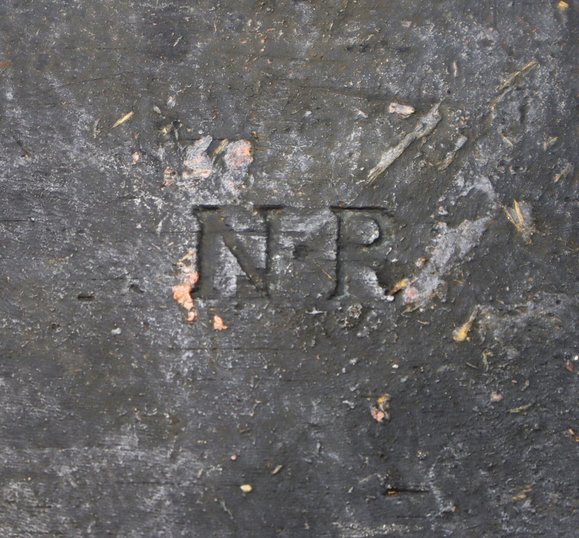A rough, weathered gray surface with "N R" engraved in the center adorns the Mexican War Cheesebox Canteen.