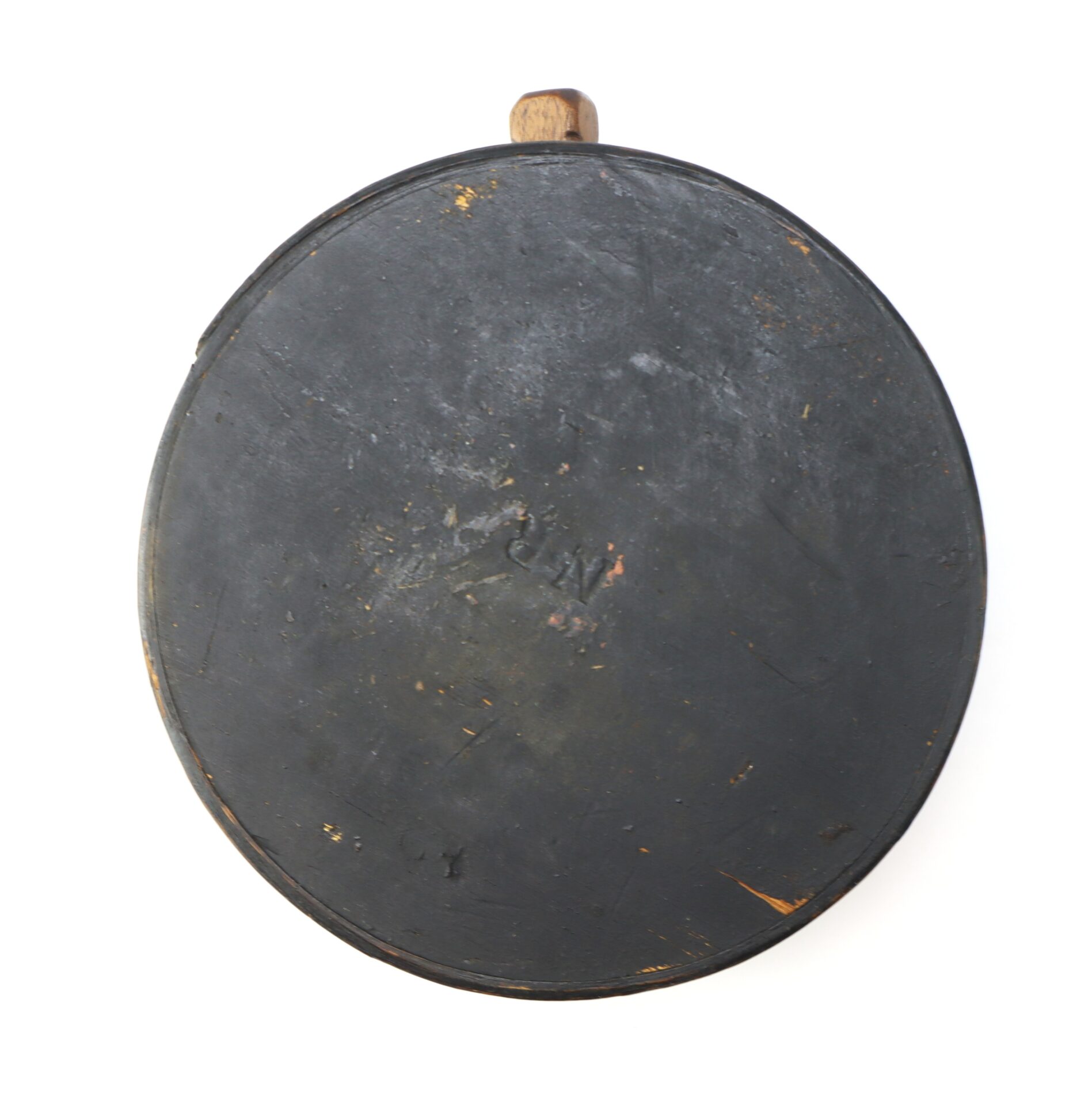 A round, flat, black Mexican War Cheesebox Canteen with a handle, resembling a worn skillet or pan, is photographed against a white background.