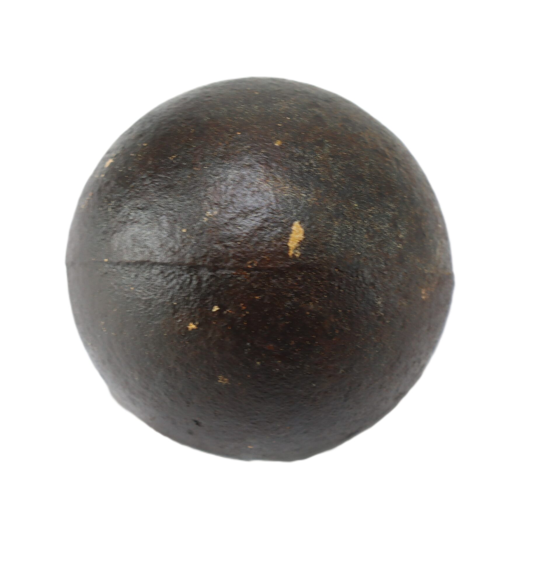 A round, dark, metal cannonball with a slightly rough surface is shown against a white background.