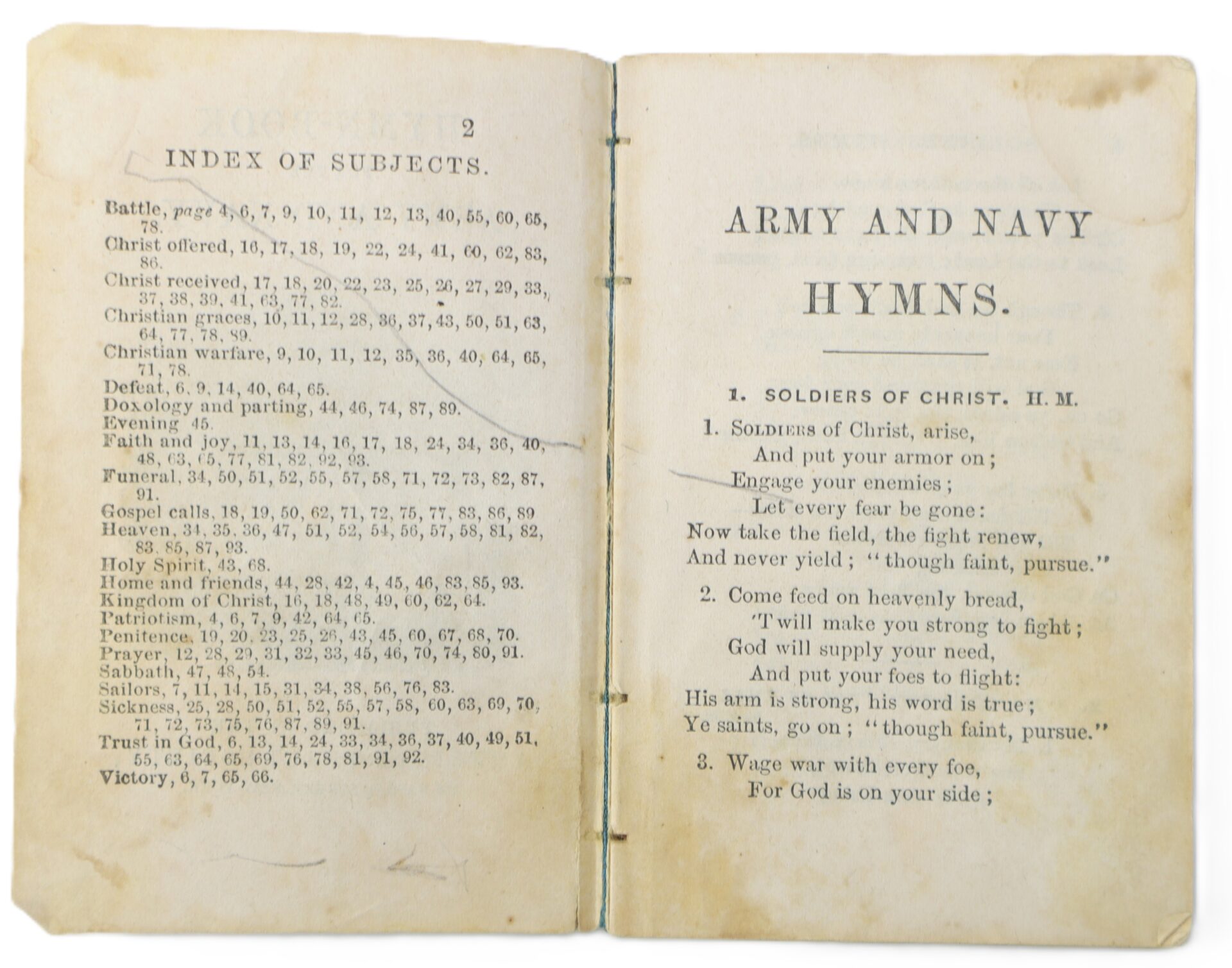 An open hymnal displays an index of subjects on the left page and the title "Army and Navy Hymns" with the hymn "Soldiers of Christ" on the right page.