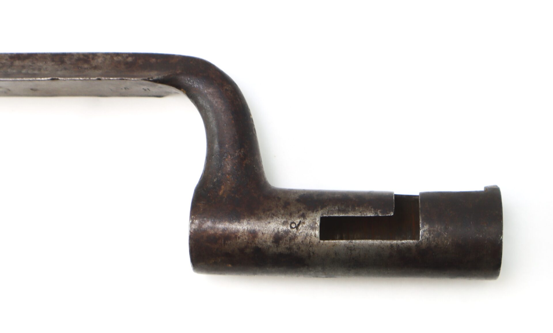 A close-up of a rusted, L-shaped metal tool with a cylindrical, notched end against a white background.