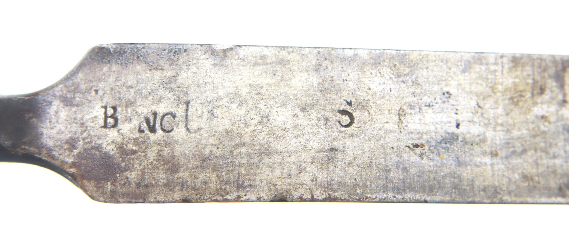 Close-up of a metal blade with faint, worn text that appears to read "B I N C L 3" stamped into the surface.