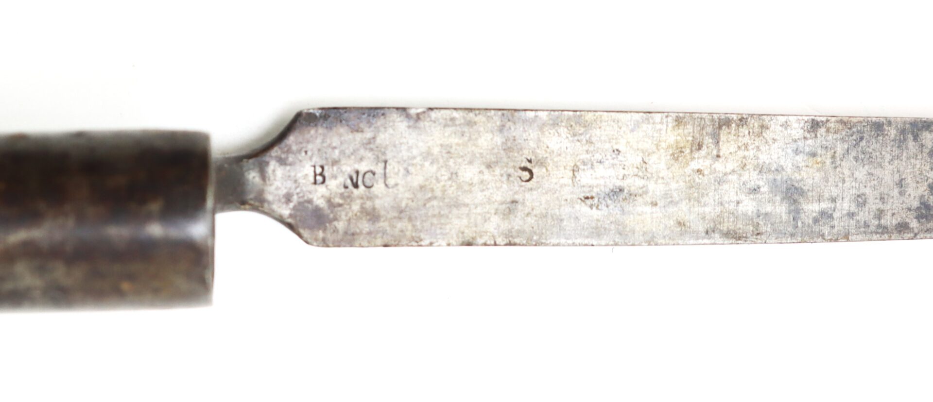 Close-up of a metal knife blade with a wooden handle, showing the stamped letters "B N C S" on the blade.