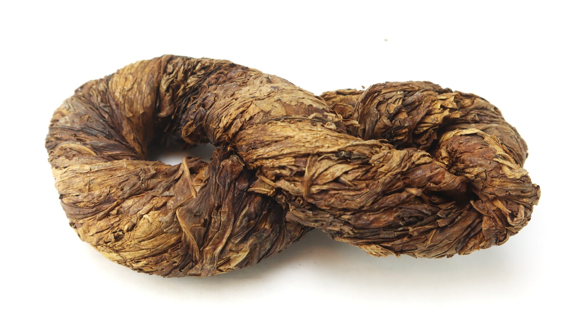 A bundle of dried tobacco leaves twisted into a circular, rope-like shape on a white background.