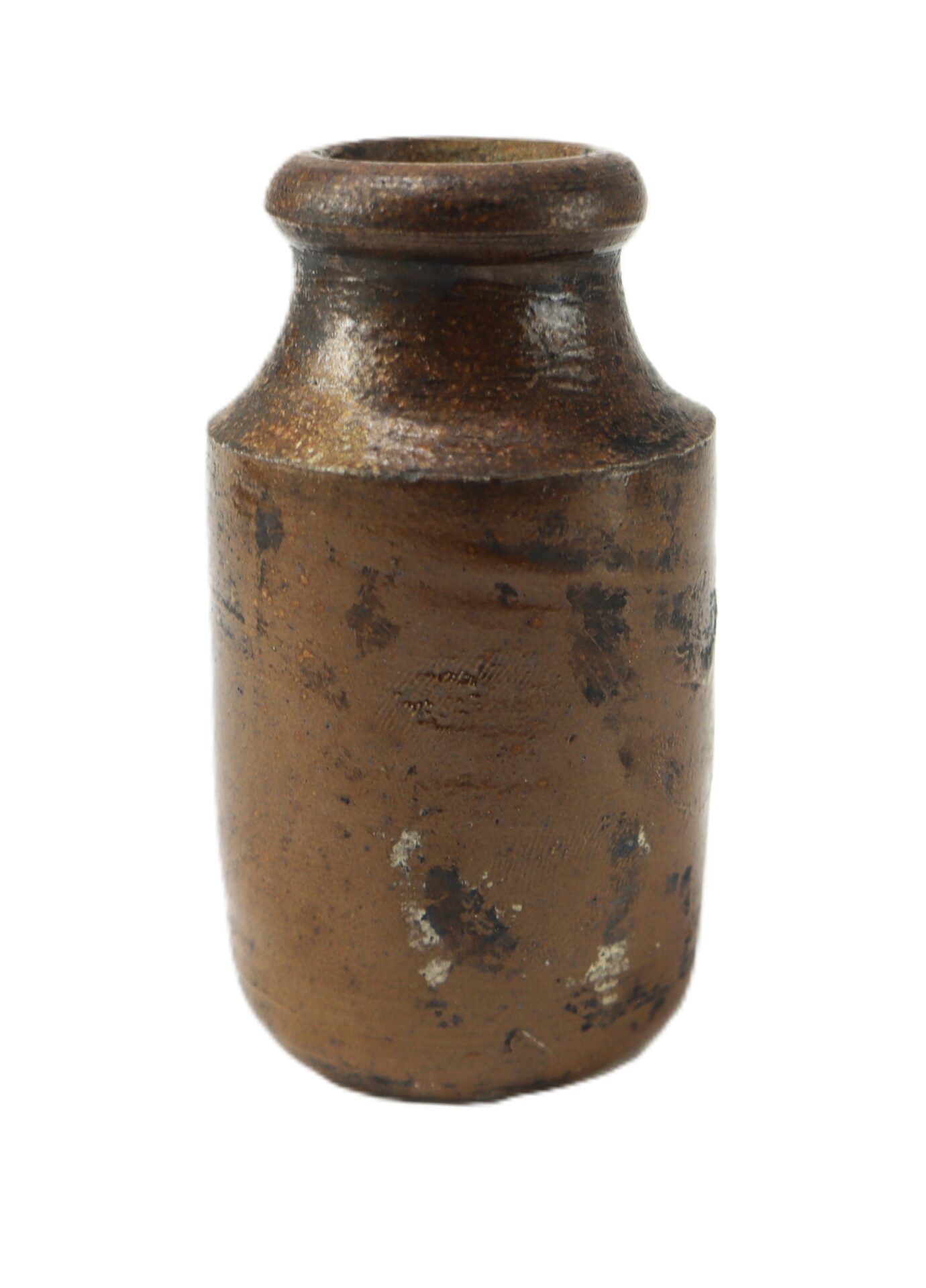 A small, brown, cylindrical ceramic jar with a narrow opening and visible signs of wear.