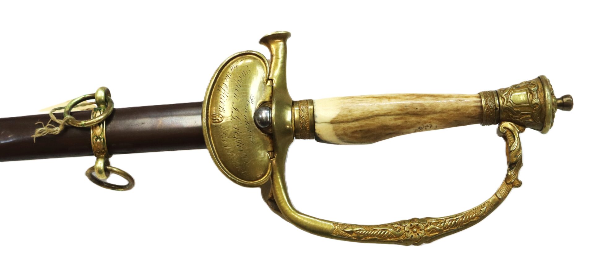 A ceremonial sword with an ornate brass hilt, a bone handle, and a scabbard featuring brass fittings and rings.