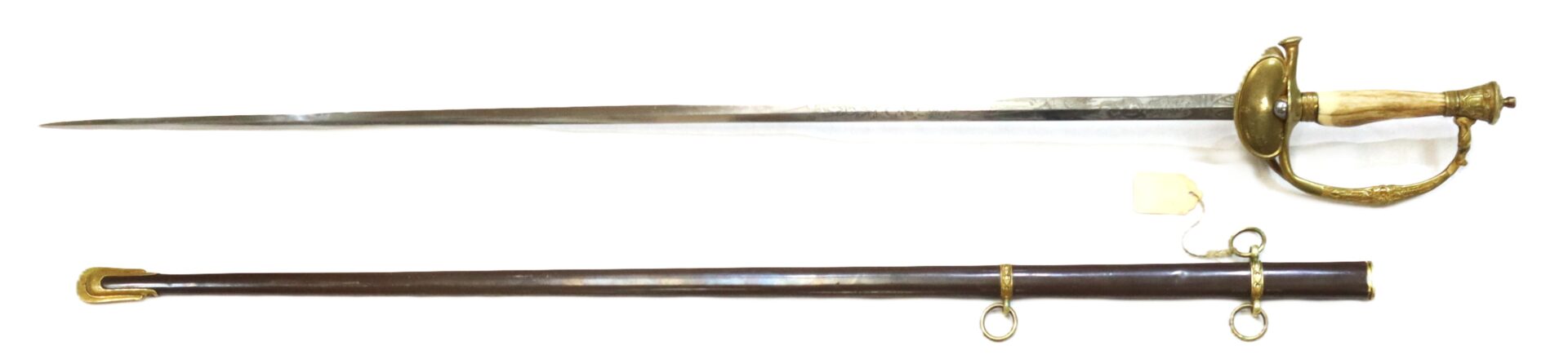 A long, thin sword with a brass guard and grip, shown above a black scabbard with brass fittings and two rings for attachment.