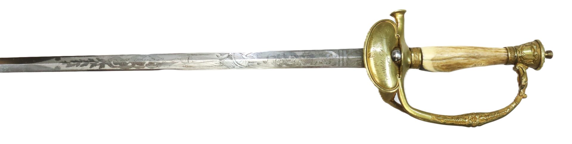 Antique sword with a decorative engraved blade, brass guard and knuckle bow, and a textured ivory or bone handle.