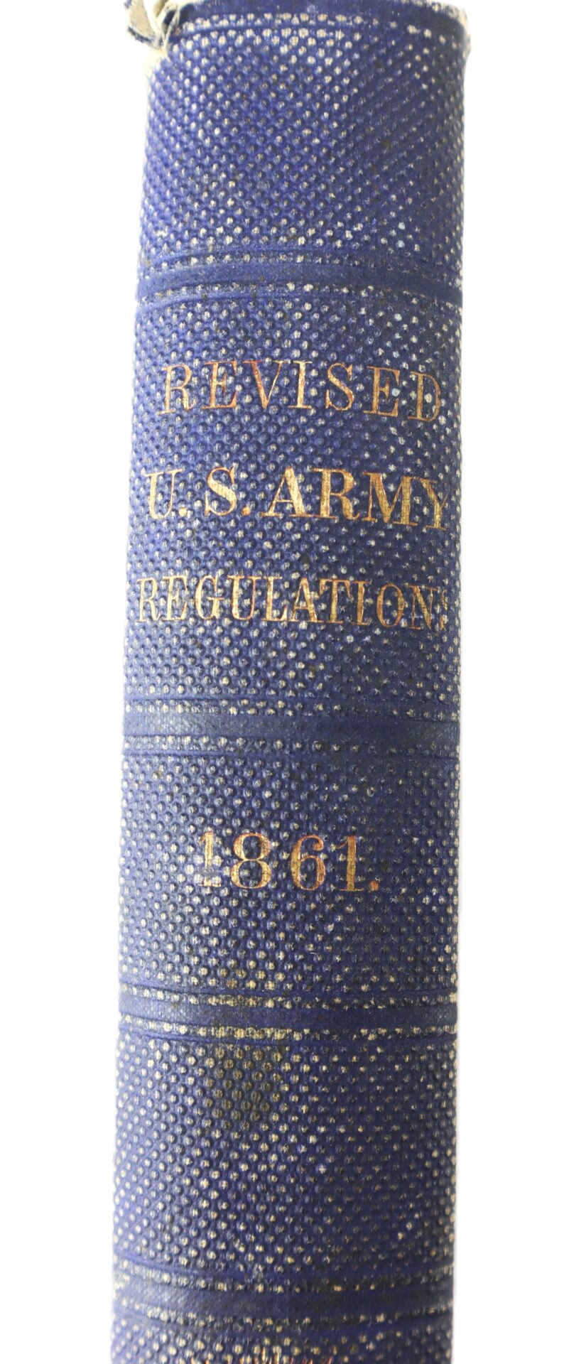 Spine of a blue hardcover book titled "Revised U.S. Army Regulations 1861" with gold embossed lettering.