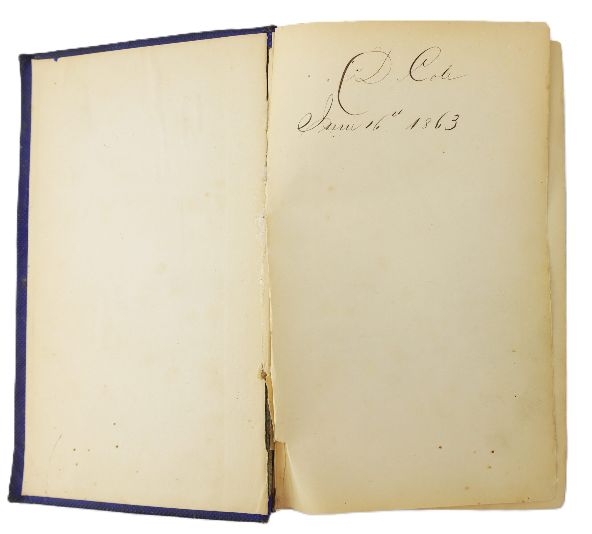 An old book opened to the inside cover, displaying handwritten text that reads: "C. Cole June 16th 1863.